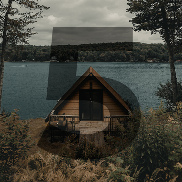 triangular shaped hobbit house by a lake.